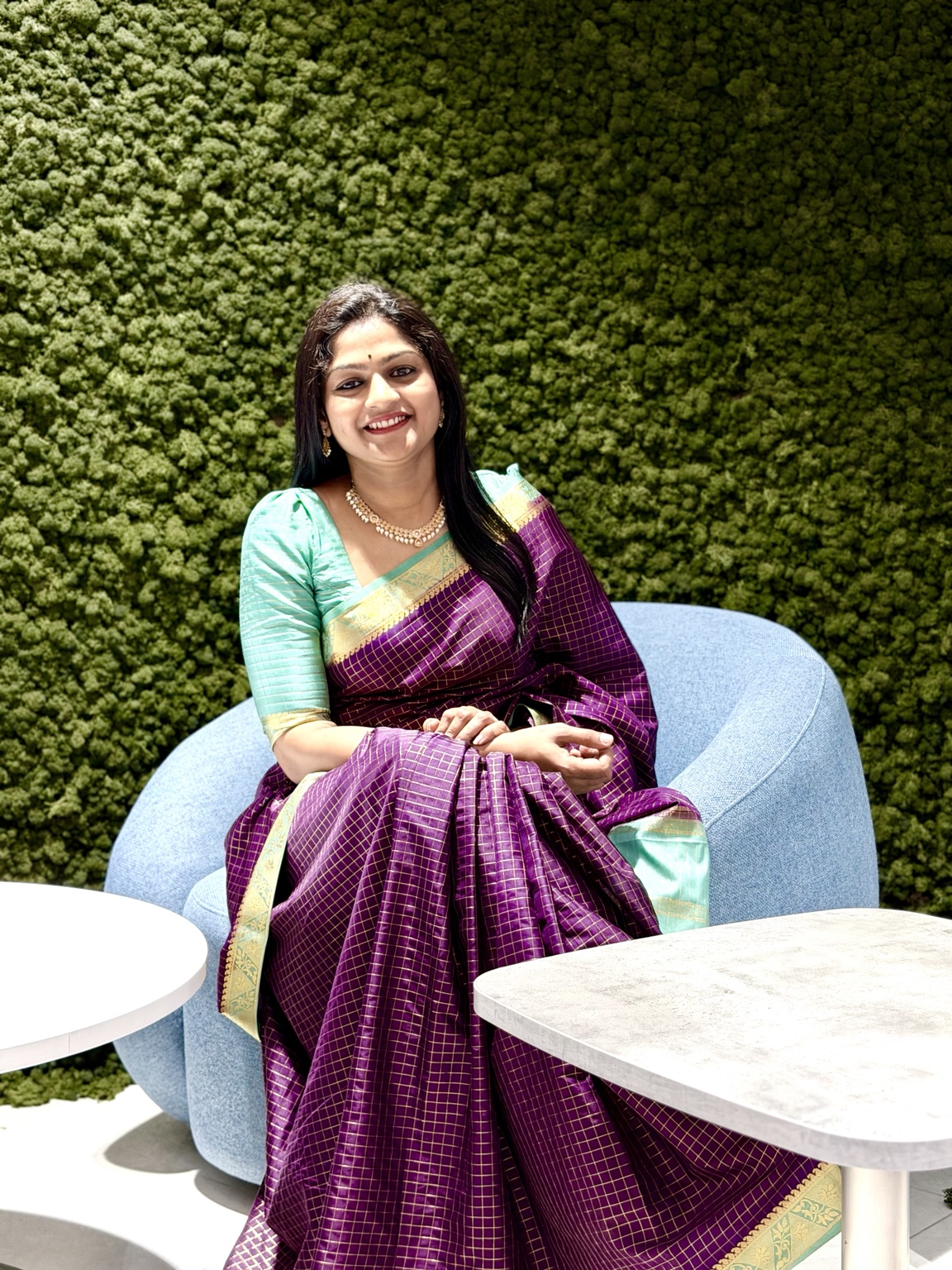 Dhanusree Praveen in a green interior setting