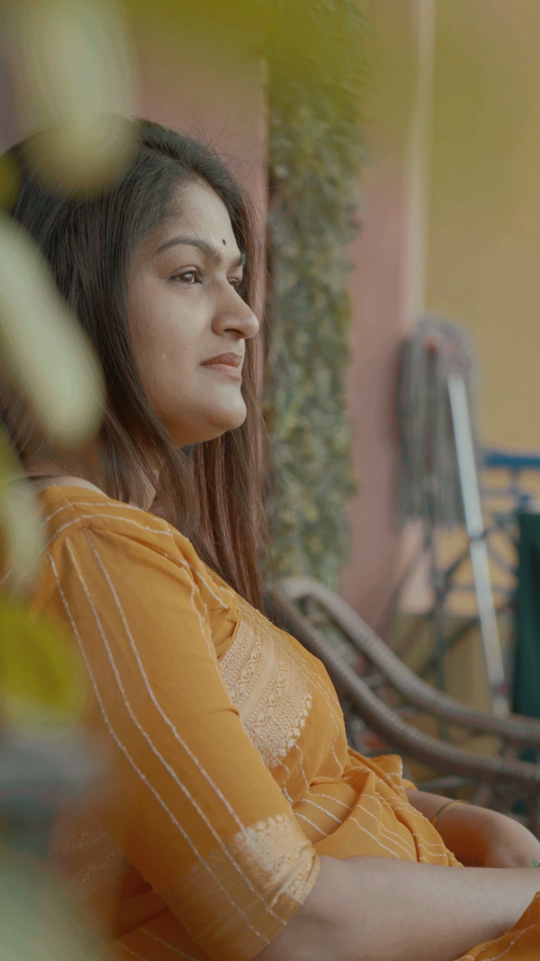Dhanusree Praveen sitting peacefully on a sunlit balcony